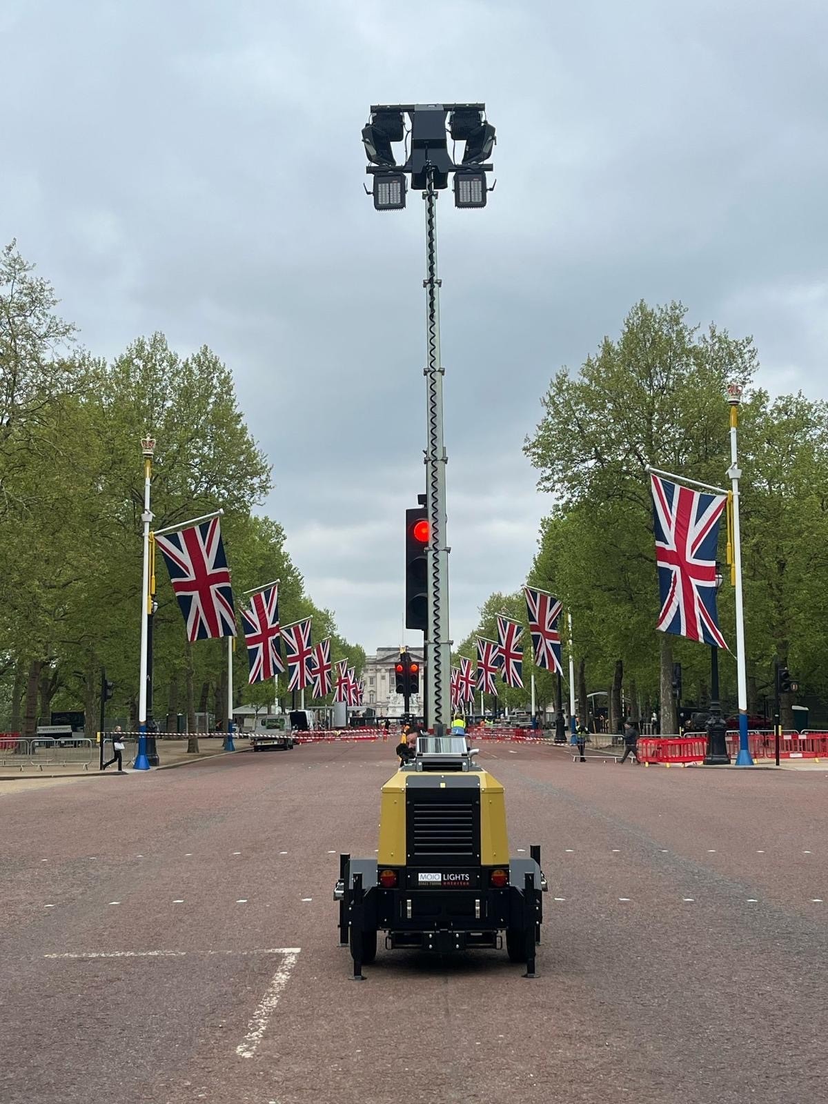 Mobile lighting tower with UK flags in background