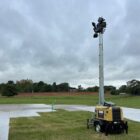 Portable lighting tower on grassy field