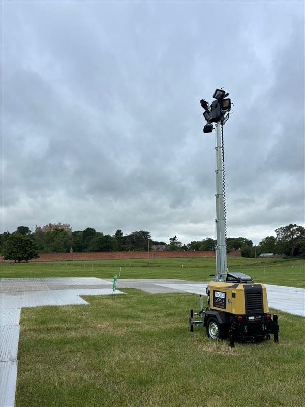 Portable lighting tower on grassy field